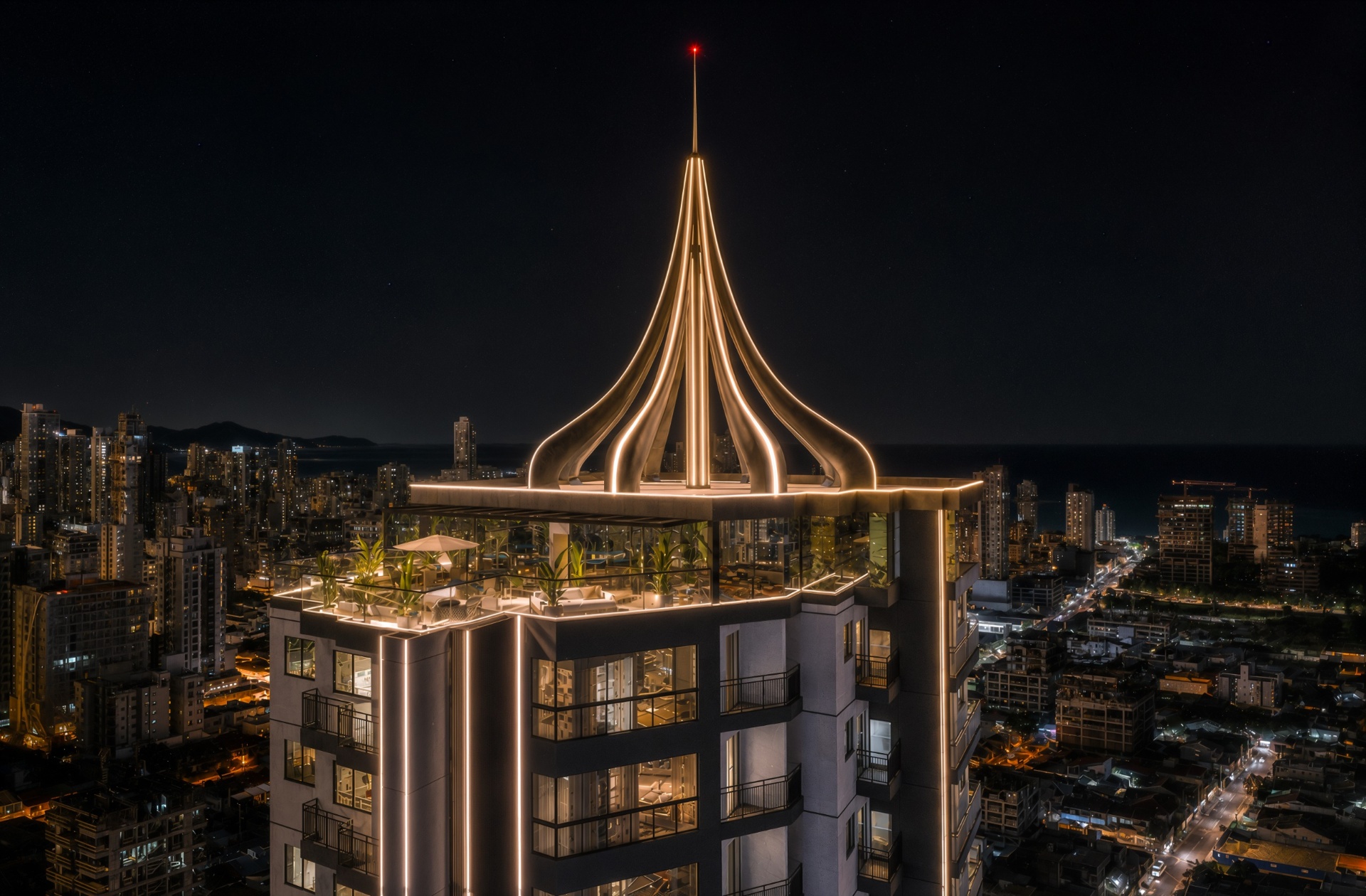 Topo iluminado da Volt Tower com vista para o mar